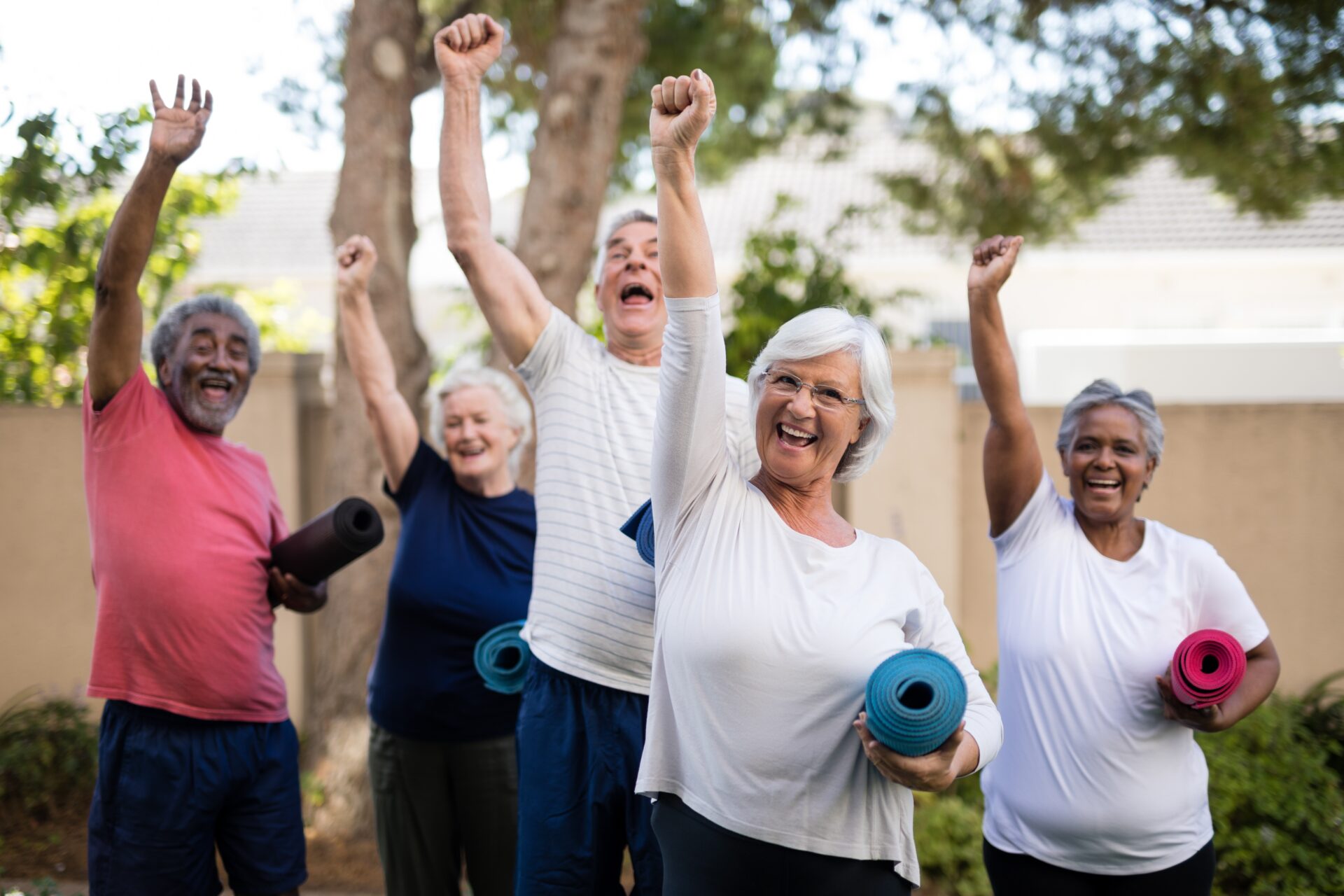 cheerful-multi-ethnic-seniors-with-exercise-mats-at-park-Miami elderly community